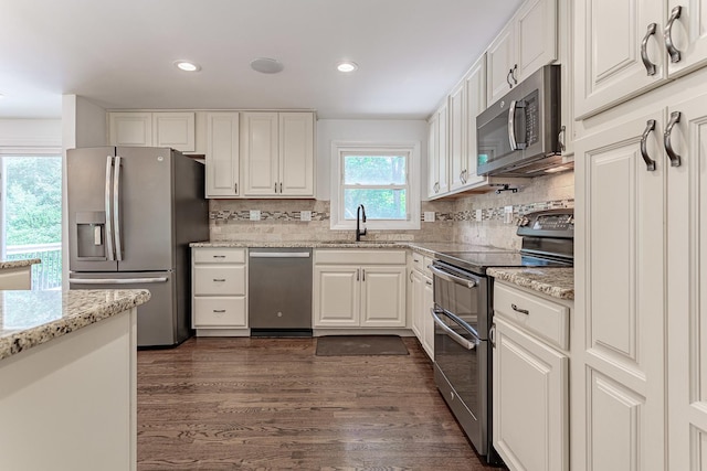 1328 Concord Ln, Schaumburg, IL 60193 - kitchen featuring appliances with stainless steel finishes, white cabinets, tasteful backsplash, dark wood finished floors, and recessed lighting
