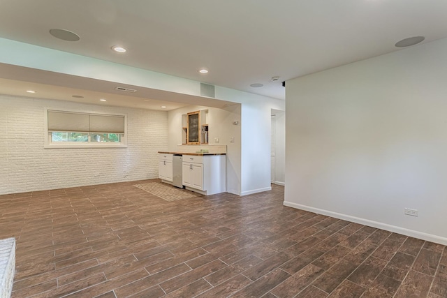 1328 Concord Ln, Schaumburg, IL 60193 - unfurnished living room with dark wood finished floors and brick wall
