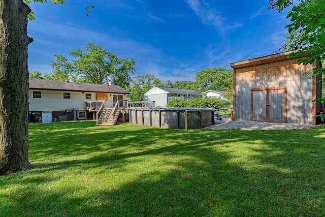 1328 Concord Ln, Schaumburg, IL 60193 - view of grassy yard featuring a wooden deck, an outdoor pool, and stairs