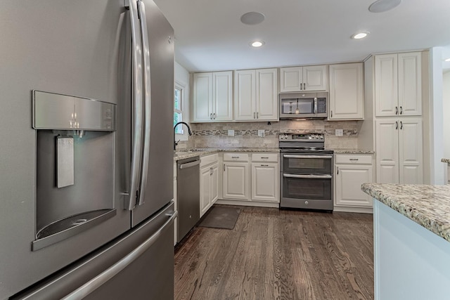 1328 Concord Ln, Schaumburg, IL 60193 - kitchen featuring appliances with stainless steel finishes, white cabinets, dark wood-style flooring, light stone counters, and recessed lighting