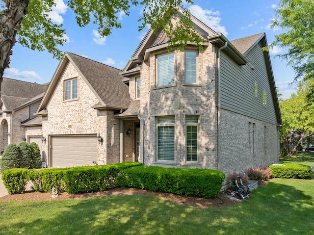 1835 Rizzi Ln, Bartlett, IL 60103 - view of front of home with brick siding, an attached garage, a front yard, and a shingled roof