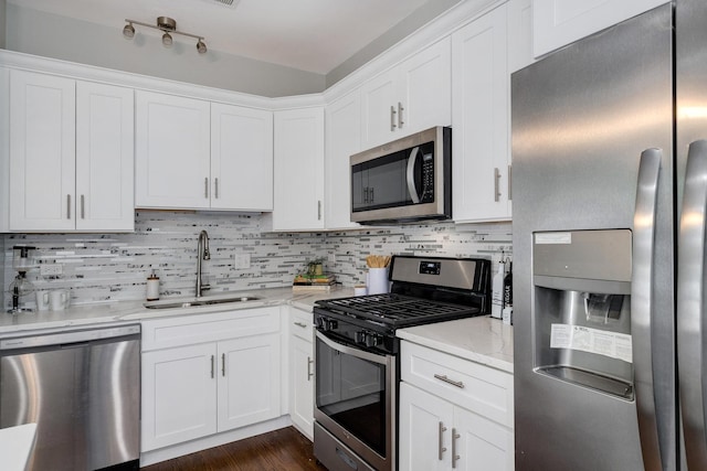 3437 S Morgan St Unit 2E, Chicago, IL 60608 - kitchen featuring stainless steel appliances, a sink, decorative backsplash, and white cabinetry