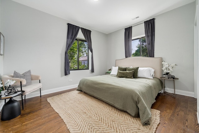 3437 S Morgan St Unit 2E, Chicago, IL 60608 - bedroom featuring multiple windows, baseboards, and wood finished floors