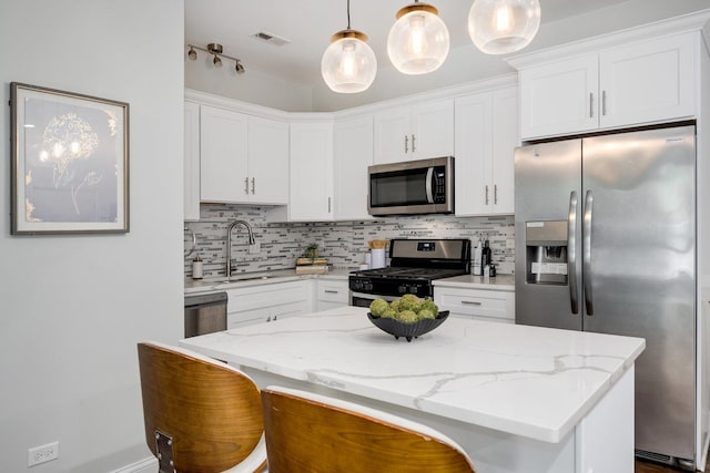 3437 S Morgan St Unit 2E, Chicago, IL 60608 - kitchen featuring appliances with stainless steel finishes, a sink, white cabinetry, and decorative backsplash