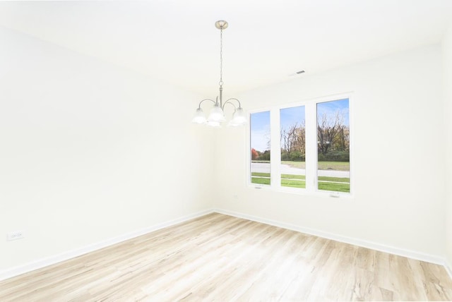 5540 Hearthside Dr, Bourbonnais, IL 60914 - spare room with light wood-type flooring, a chandelier, and baseboards