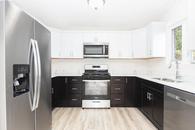 5540 Hearthside Dr, Bourbonnais, IL 60914 - kitchen featuring appliances with stainless steel finishes, a sink, white cabinets, and light countertops