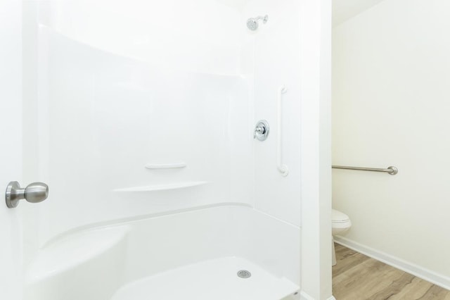 5542 Hearthside Dr, Bourbonnais, IL 60914 - bathroom featuring wood finished floors, toilet, a shower, and baseboards