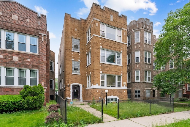 8122 S Evans Ave, Chicago, IL 60619 - view of building exterior with a fenced front yard