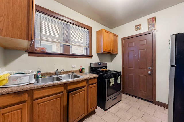 8122 S Evans Ave, Chicago, IL 60619 - kitchen featuring appliances with stainless steel finishes, a sink, brown cabinetry, and light tile patterned floors