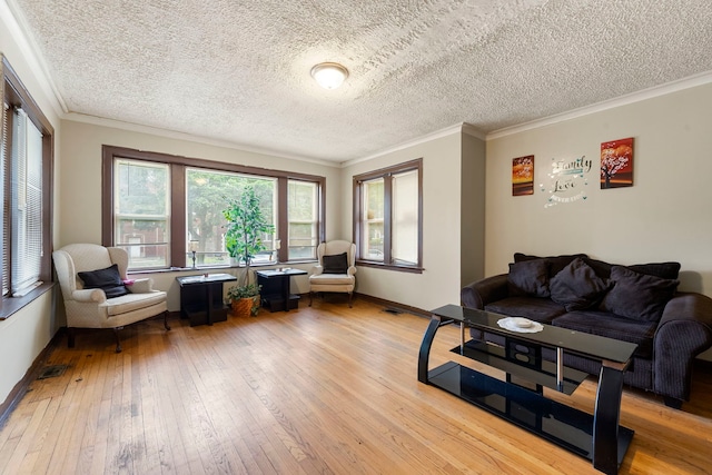 8122 S Evans Ave, Chicago, IL 60619 - living room featuring light wood-style flooring, ornamental molding, a textured ceiling, and baseboards