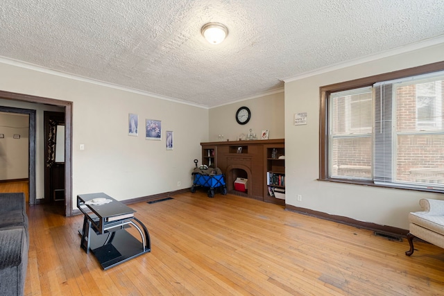 8122 S Evans Ave, Chicago, IL 60619 - unfurnished room with a textured ceiling, hardwood / wood-style flooring, ornamental molding, a fireplace, and baseboards