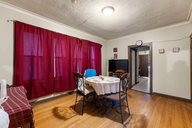8122 S Evans Ave, Chicago, IL 60619 - dining space featuring a textured ceiling, hardwood / wood-style floors, crown molding, and baseboards