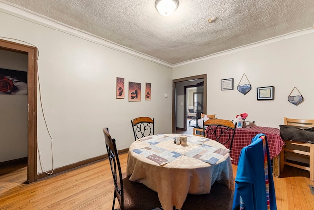 8122 S Evans Ave, Chicago, IL 60619 - dining space featuring light wood finished floors, a textured ceiling, and crown molding