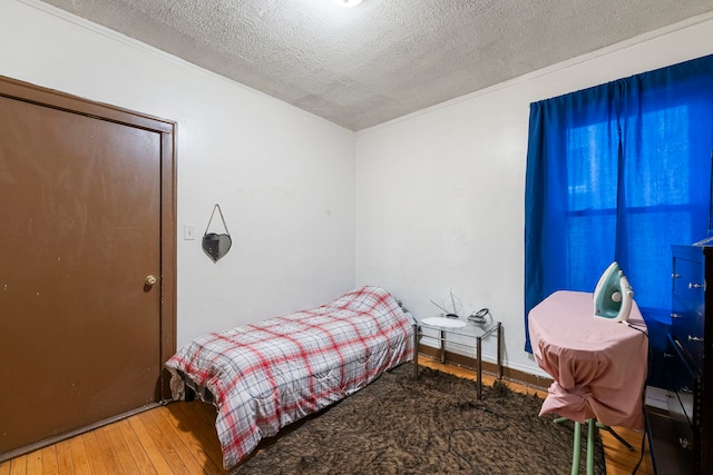 8122 S Evans Ave, Chicago, IL 60619 - bedroom with hardwood / wood-style flooring and a textured ceiling
