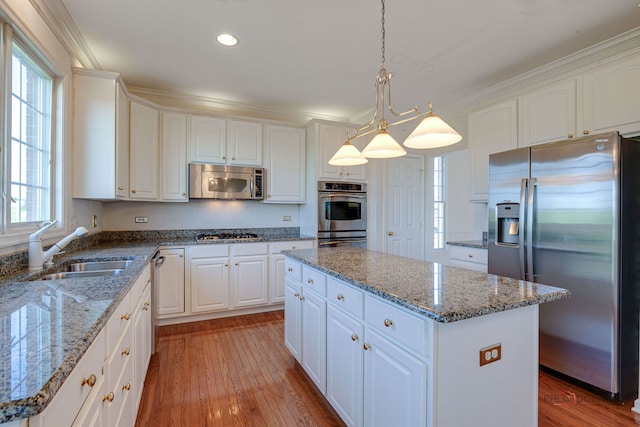 15 Open Pkwy N, Hawthorn Woods, IL 60047 - kitchen with appliances with stainless steel finishes, a kitchen island, light wood finished floors, white cabinetry, and recessed lighting