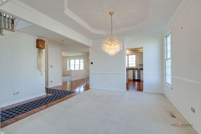 15 Open Pkwy N, Hawthorn Woods, IL 60047 - unfurnished dining area with healthy amount of natural light, a chandelier, crown molding, a tray ceiling, and light wood-type flooring