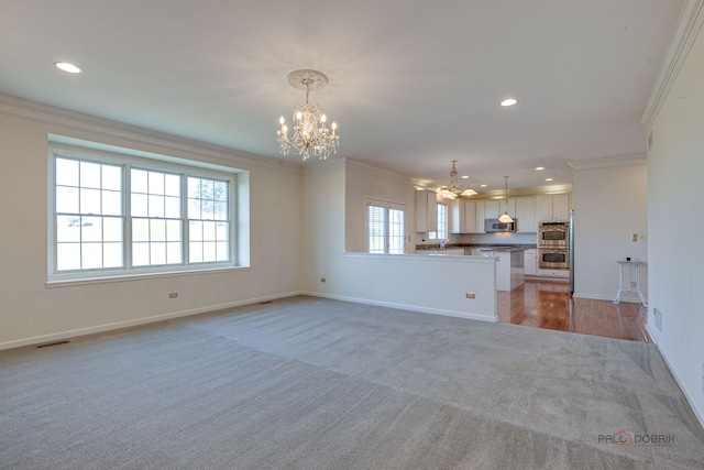 15 Open Pkwy N, Hawthorn Woods, IL 60047 - unfurnished living room featuring a chandelier, light colored carpet, crown molding, healthy amount of natural light, and recessed lighting