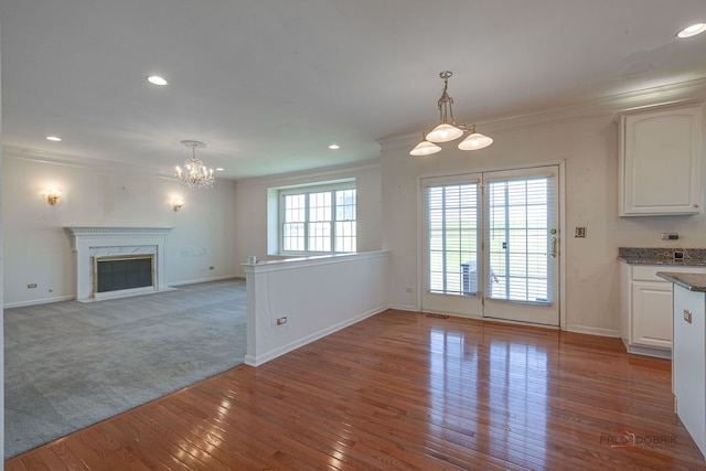 15 Open Pkwy N, Hawthorn Woods, IL 60047 - unfurnished dining area with a chandelier, ornamental molding, hardwood / wood-style flooring, recessed lighting, and a high end fireplace