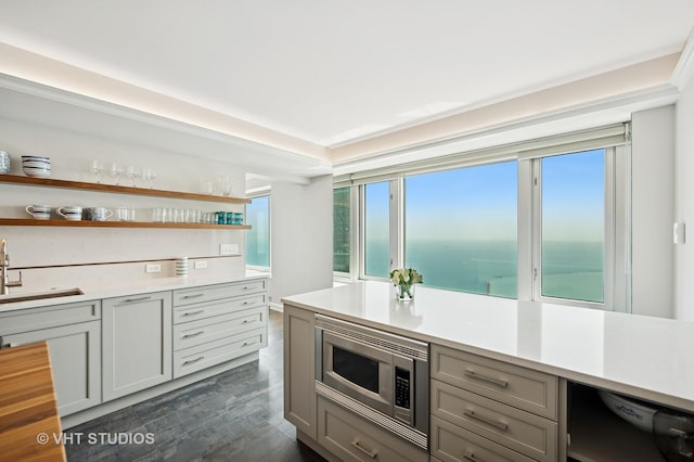 132 E Delaware Pl Unit 5106, Chicago, IL 60611 - kitchen with stainless steel microwave, gray cabinets, light countertops, dishwasher, and open shelves