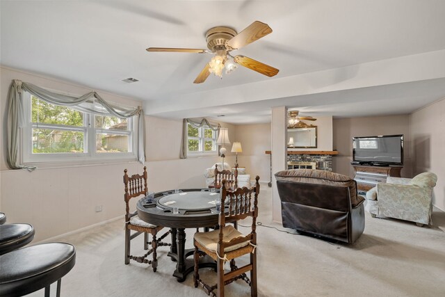 5927 Sherman Dr, Woodridge, IL 60517 - dining space with ceiling fan, light carpet, baseboards, and a stone fireplace