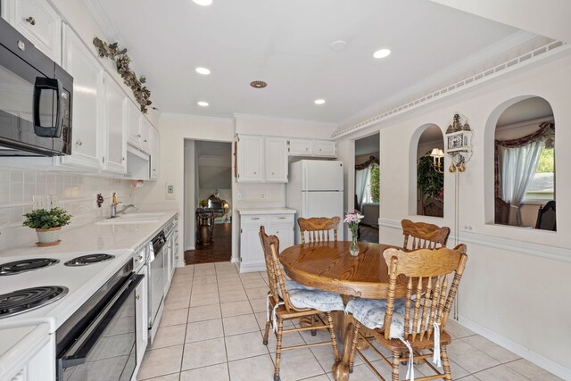 5927 Sherman Dr, Woodridge, IL 60517 - kitchen with black microwave, freestanding refrigerator, stainless steel dishwasher, a sink, and light countertops