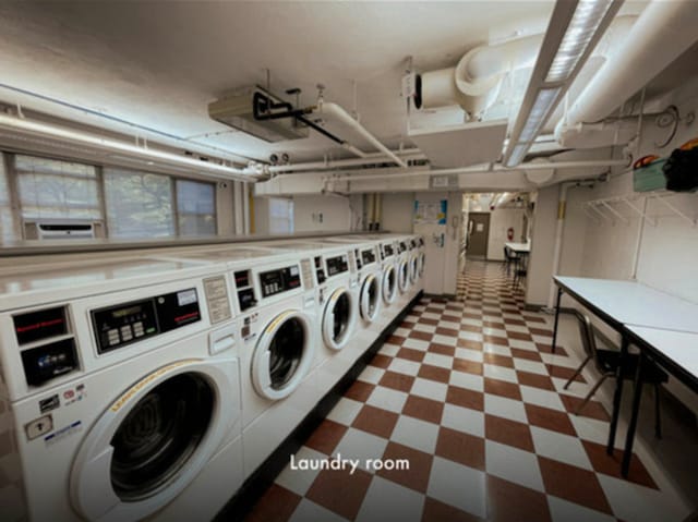 6301 N Sheridan Rd Unit 24C, Chicago, IL 60660 - shared laundry featuring washer and clothes dryer and tile patterned floors