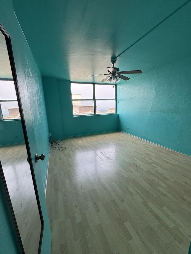 6301 N Sheridan Rd Unit 24C, Chicago, IL 60660 - spare room with wood finished floors, ceiling fan, and a textured wall