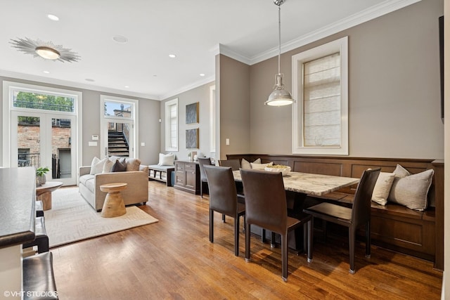 1230 W Cornelia Ave, Chicago, IL 60657 - dining room with light wood-style flooring, ornamental molding, stairs, wainscoting, and recessed lighting