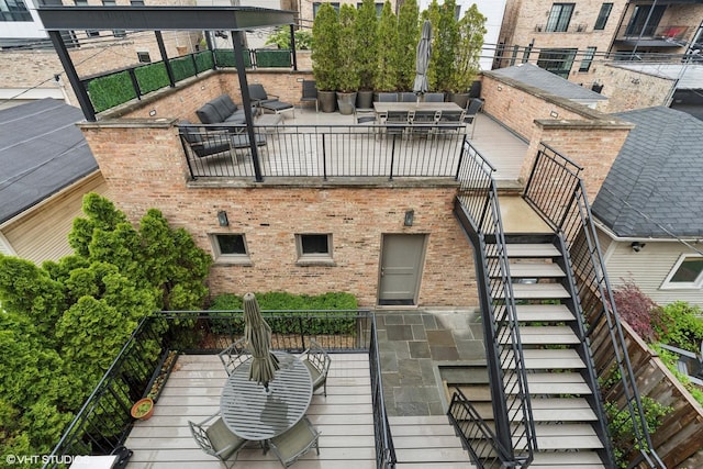 1230 W Cornelia Ave, Chicago, IL 60657 - rear view of property with stairs, brick siding, a patio area, and outdoor lounge area