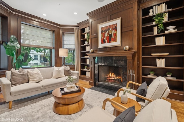 1230 W Cornelia Ave, Chicago, IL 60657 - living room featuring a fireplace, wood finished floors, ornamental molding, built in shelves, and recessed lighting
