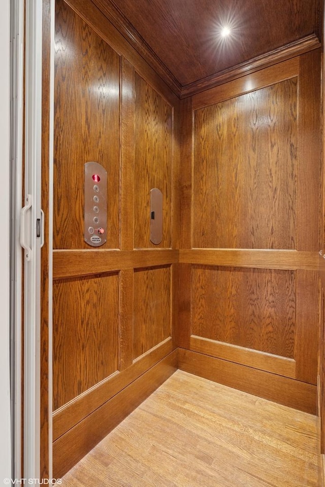 1230 W Cornelia Ave, Chicago, IL 60657 - elevator featuring wood walls and wood finished floors