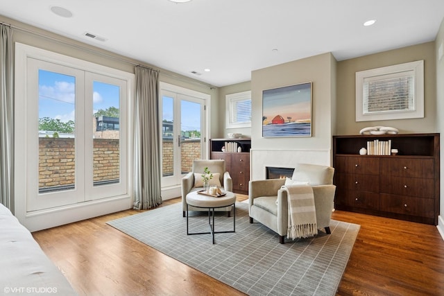 1230 W Cornelia Ave, Chicago, IL 60657 - sitting room with french doors, a glass covered fireplace, wood finished floors, and recessed lighting