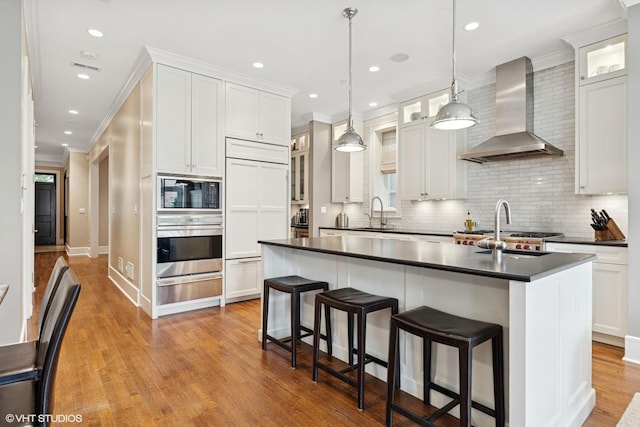 1230 W Cornelia Ave, Chicago, IL 60657 - kitchen featuring wall chimney exhaust hood, oven, a warming drawer, dark countertops, and decorative backsplash