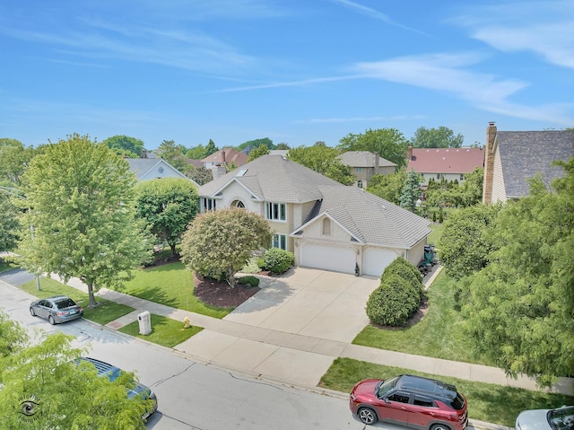 16924 Yearling Crossing Dr, Orland Park, IL 60467 - view of front facade with an attached garage, concrete driveway, a front lawn, and a residential view