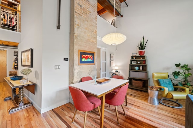 2111 W Churchill St Unit 112, Chicago, IL 60647 - dining area with a towering ceiling and wood finished floors