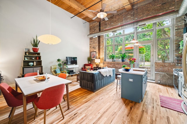 2111 W Churchill St Unit 112, Chicago, IL 60647 - dining area with brick wall, a high ceiling, a wooden ceiling with exposed beams, ceiling fan, and light wood-type flooring
