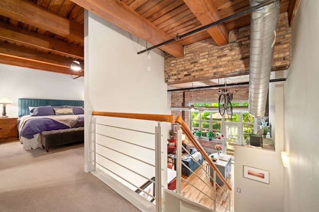 2111 W Churchill St Unit 112, Chicago, IL 60647 - hallway with a wood ceiling with exposed beams, carpet floors, and brick wall