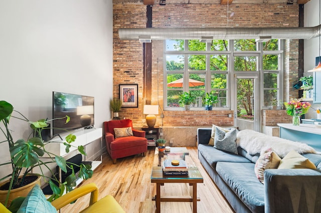 2111 W Churchill St Unit 112, Chicago, IL 60647 - living area featuring brick wall and wood finished floors