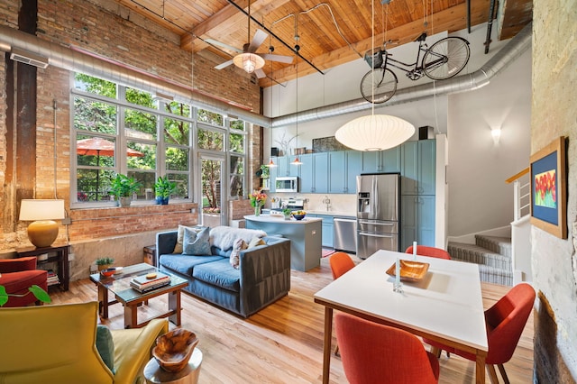 2111 W Churchill St Unit 112, Chicago, IL 60647 - living area with a towering ceiling, a wooden ceiling with exposed beams, light wood-type flooring, ceiling fan, and stairs