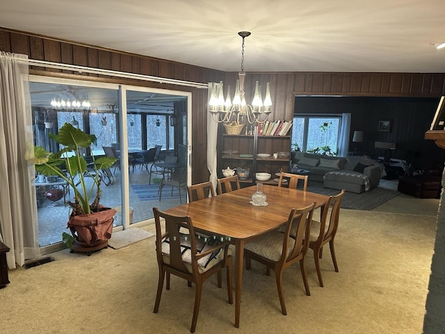 27125 N Williams Park Rd N, Wauconda, IL 60084 - dining area featuring a chandelier, wooden walls, and light colored carpet