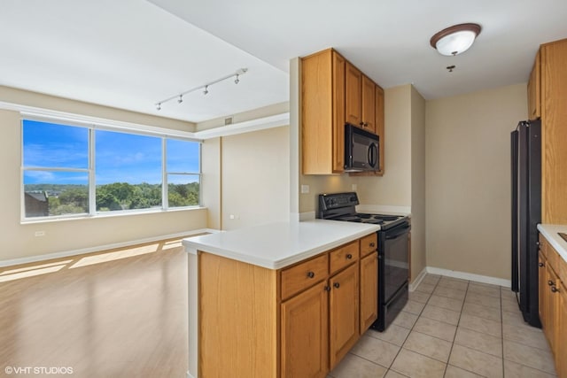 77 S Evergreen Ave Unit 707, Arlington Heights, IL 60005 - kitchen with black appliances, track lighting, baseboards, light countertops, and brown cabinets