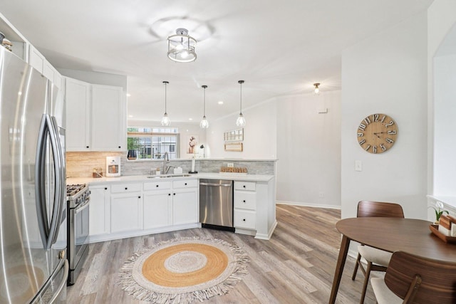245 Grays Dr, Oswego, IL 60543 - kitchen featuring stainless steel appliances, a sink, tasteful backsplash, and a peninsula