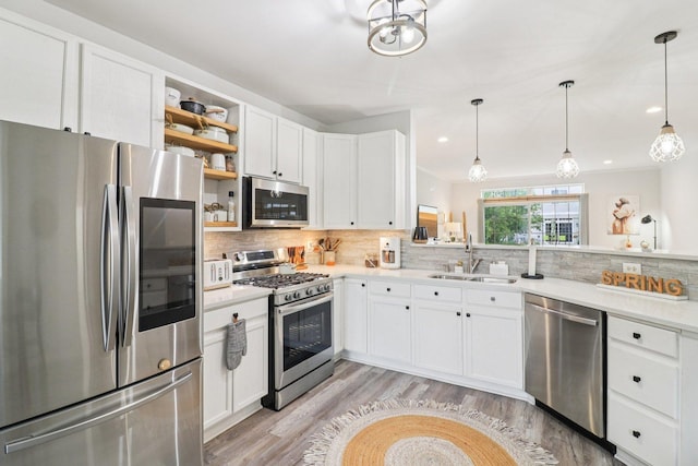 245 Grays Dr, Oswego, IL 60543 - kitchen with appliances with stainless steel finishes, a sink, open shelves, light wood-style flooring, and backsplash