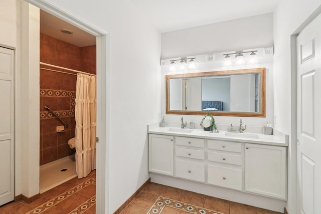 245 Grays Dr, Oswego, IL 60543 - bathroom with tile patterned floors, tiled shower, double vanity, and baseboards