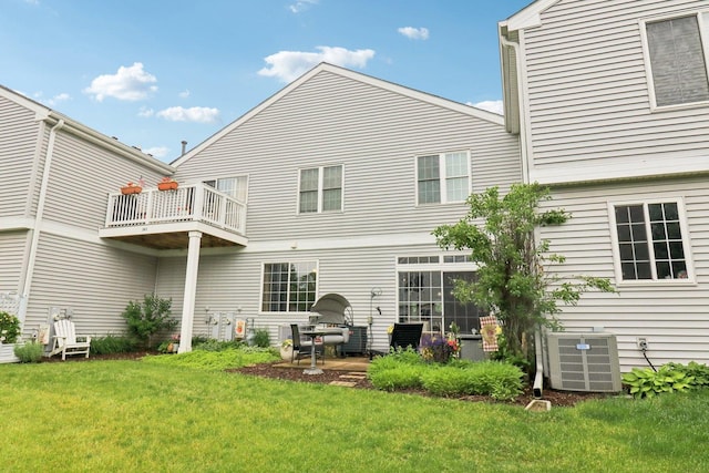 245 Grays Dr, Oswego, IL 60543 - back of house with central air condition unit, a yard, and a balcony