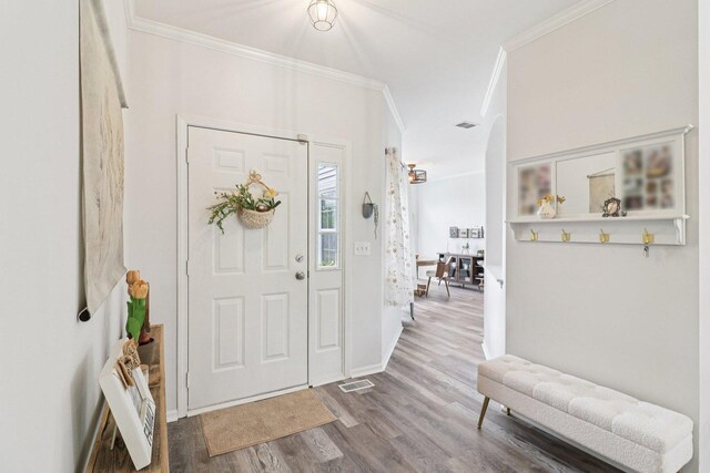 245 Grays Dr, Oswego, IL 60543 - entryway featuring ornamental molding, wood finished floors, and baseboards