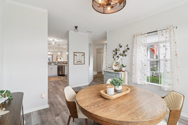 245 Grays Dr, Oswego, IL 60543 - dining space featuring ornamental molding, wood finished floors, and baseboards