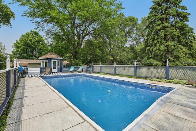20214 Harmony Rd, Marengo, IL 60152 - view of pool with an exterior structure, an outbuilding, a patio, and view of wooded area