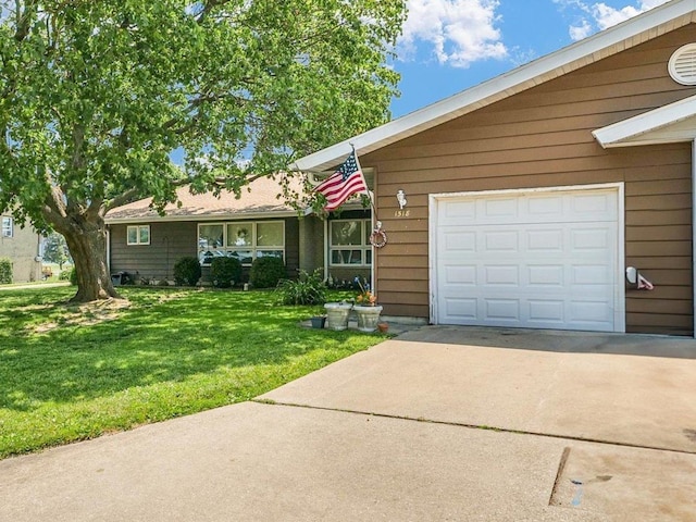 1518 Golfview Rd Unit 1, Rantoul, IL 61866 - view of front of house with driveway, a front yard, and an attached garage