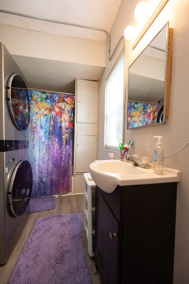 602 S Elm St, Villa Grove, IL 61956 - bathroom with stacked washer / drying machine, vanity, wood finished floors, and a shower with shower curtain